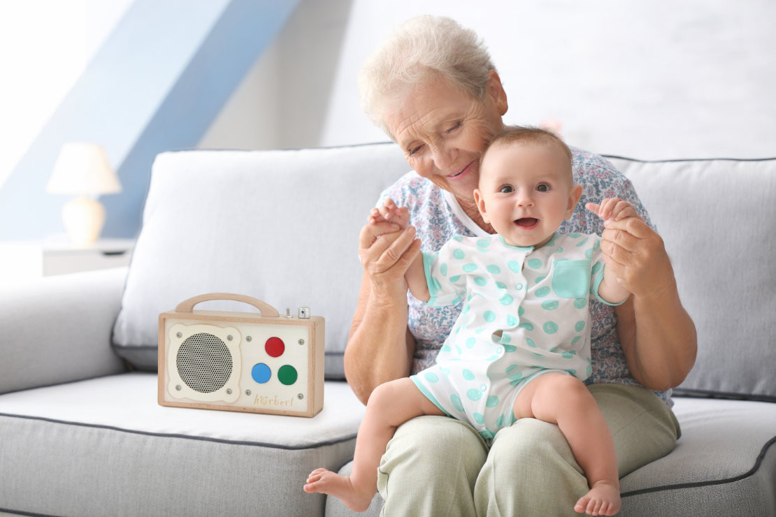 Seniorin mit Kind auf dem Schoß neben dem 3 Tasten hörbert - © Winzki/Africa Studio - stock.adobe.com Seniorin mit Kind auf dem Schoß neben dem 3 Tasten hörbert - © Winzki/Africa Studio - stock.adobe.com